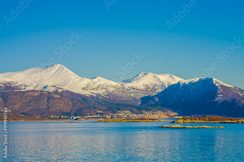 Outdoor view of mountain range in Norway. The beautiful mountain covered partial with snow in Hurtigruten region in Norway