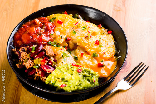 nachos with melted cheese, guacamole and red beans