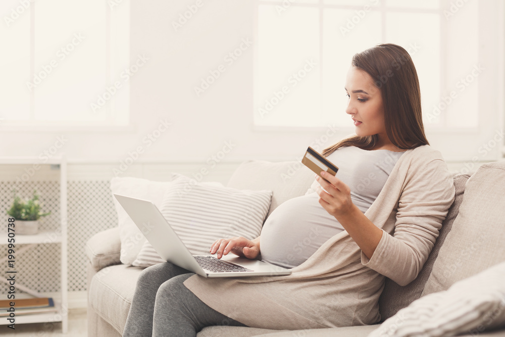 Pensive woman shopping online with credit card Pensive woman shopping online with credit card