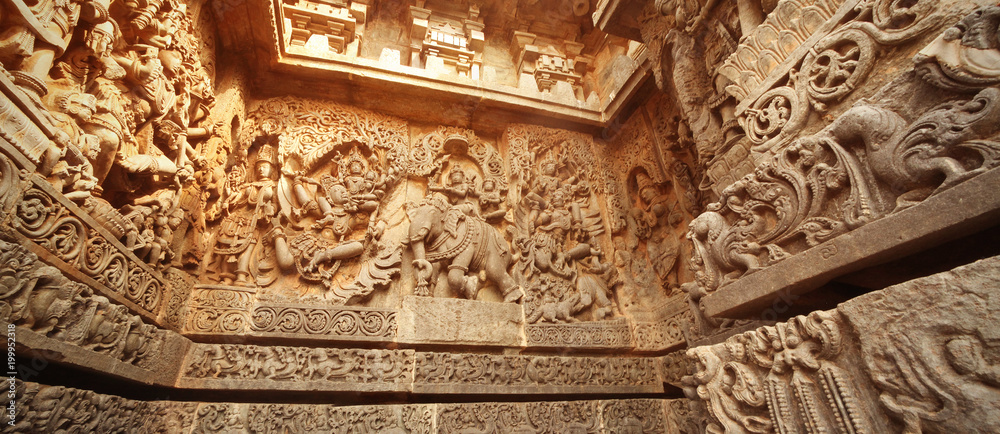 India Belur temple. Old stone wall with sculptures