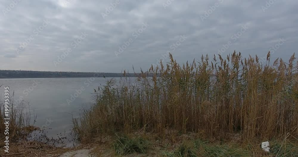 View of the flying drones opens the landscape to the smooth water of the river with a fisherman's boat, Aerial shooting View of the flying drones opens the landscape to the smooth water of the river with a fisherman's boat, Aerial shooting