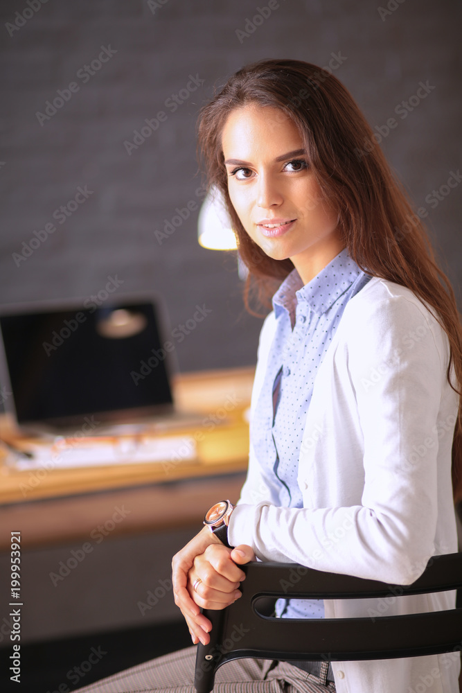 Young female working sitting at a desk.