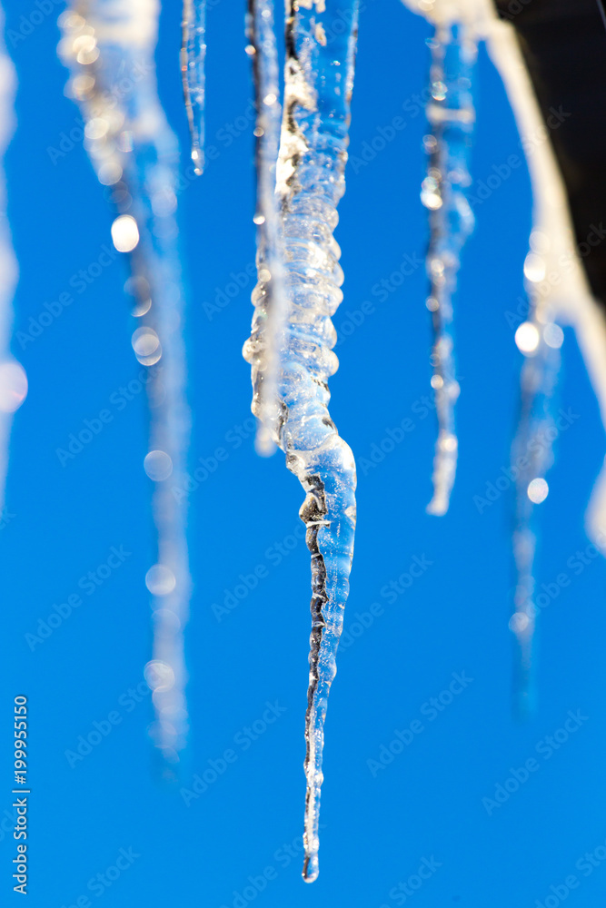 Icicle against the blue sky in winter Icicle against the blue sky in winter