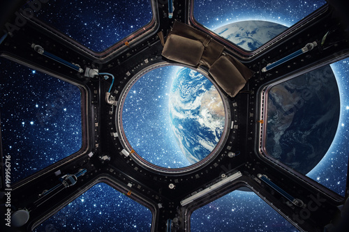 Earth and galaxy in spaceship international space station window porthole. Elements of this image furnished by NASA