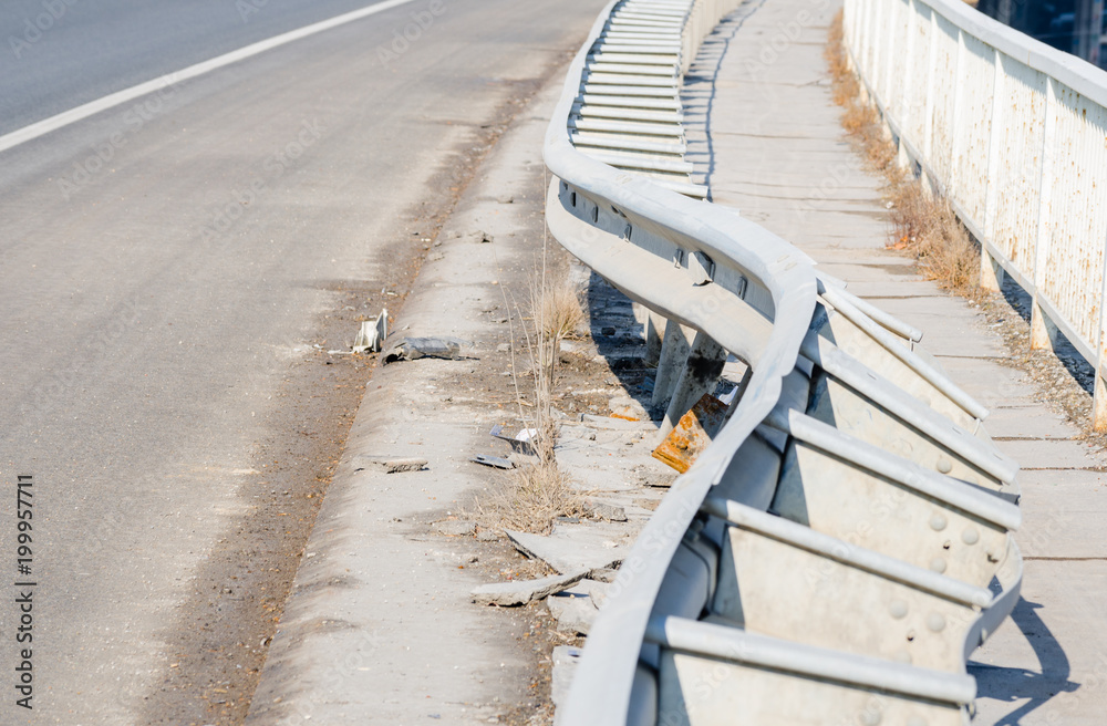 Obraz premium Damaged metal safety fence on the bridge from car crash accident from unsafe driving