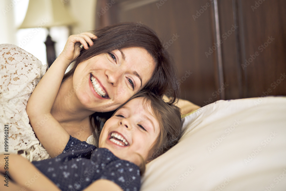 mother playing with her baby in the bedroom mother playing with her baby in the bedroom