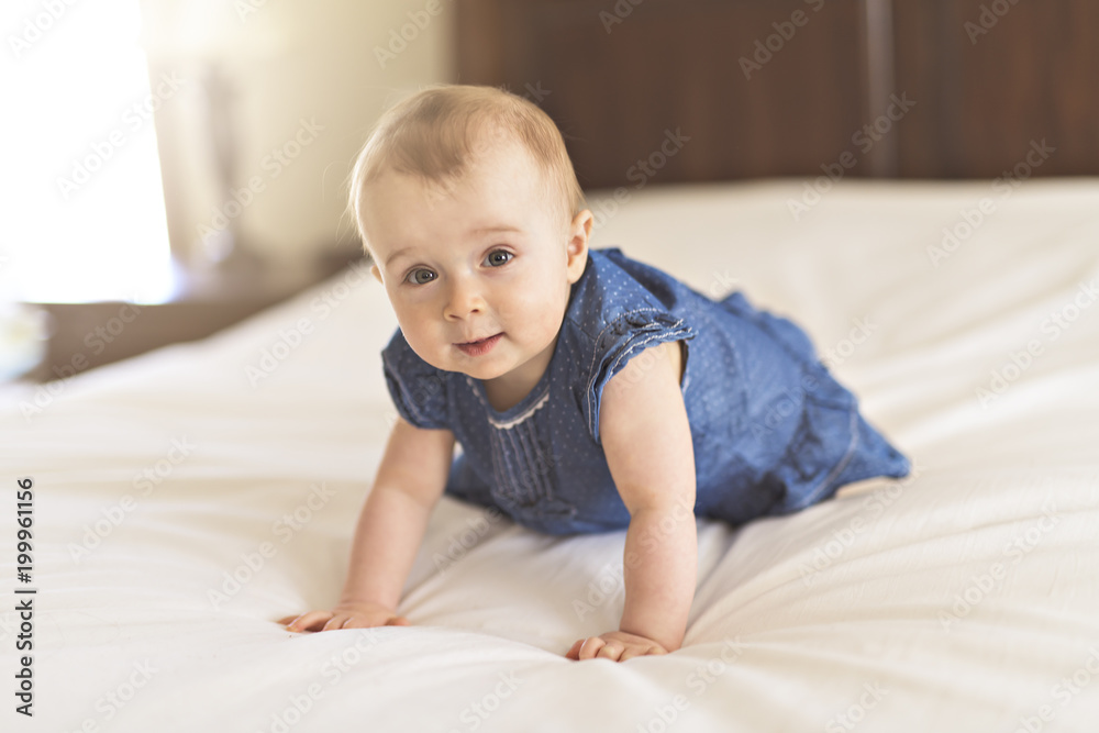 Portrait of a baby on the bed in her room Portrait of a baby on the bed in her room