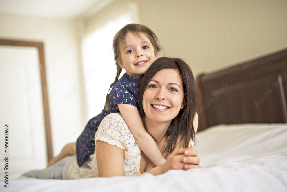 mother playing with her baby in the bedroom mother playing with her baby in the bedroom