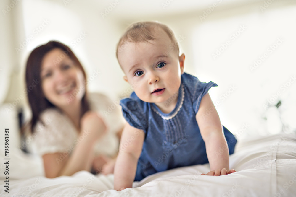 mother playing with her baby in the bedroom mother playing with her baby in the bedroom