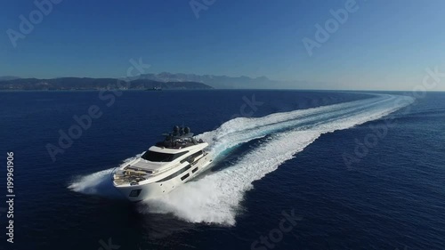 Aerial front view of a luxury yacht sailing at full speed. photo