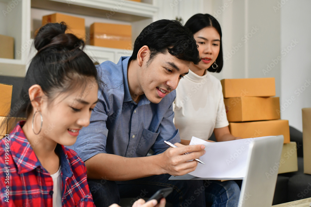 Sme business concept. Young Asian people are packing their packages.Delivery business Small and Medium Enterprise (SMEs). Young man is working in the house.Young Owner Start up for Business Online. Sme business concept. Young Asian people are packing their packages.Delivery business Small and Medium Enterprise (SMEs). Young man is working in the house.Young Owner Start up for Business Online.