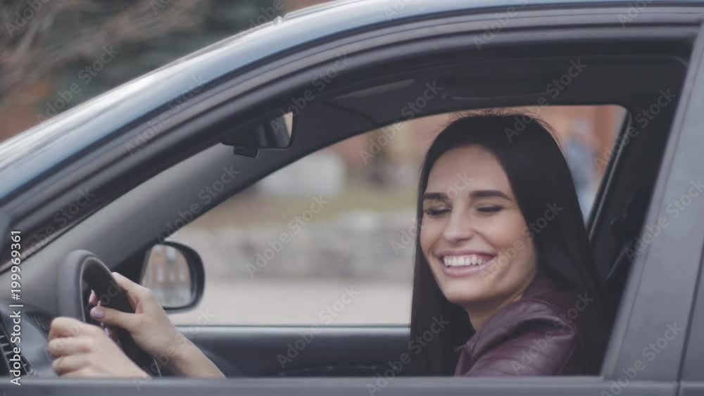 cheerful woman laughing and fooling around in the car cheerful woman laughing and fooling around in the car
