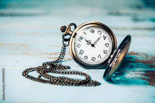 Vintage pocket watch on wooden board