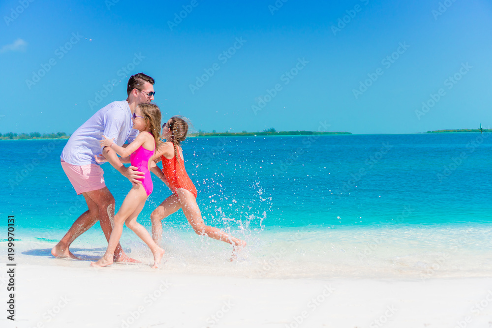 Happy family enjoying beach time and have a lot of fun