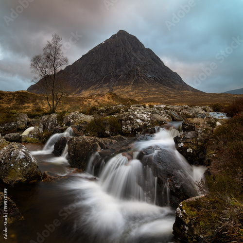 The beautiful waterfall with in the background the Buachaille in Glencoe area Scotland
