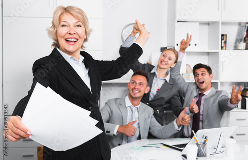 Happy business group with woman at office photo