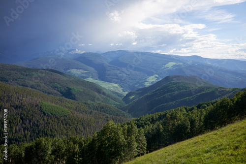 Scenic green forested valley and cloudscape