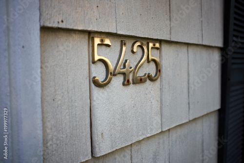 Brass number 5425 on an exterior wall