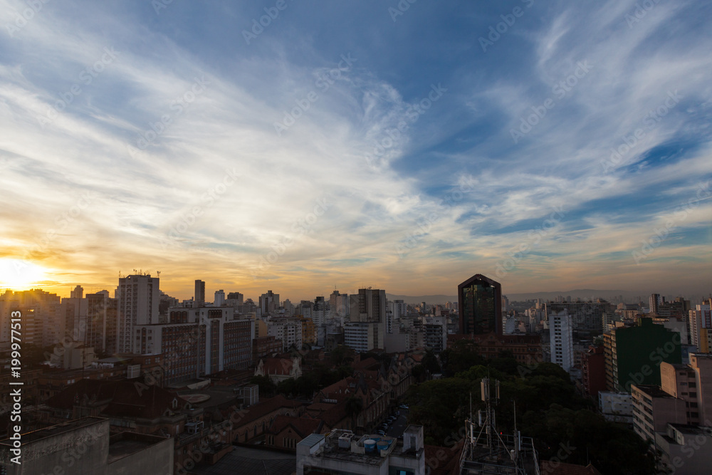 Silhouettes of buildings at dusk in São Paulo city.