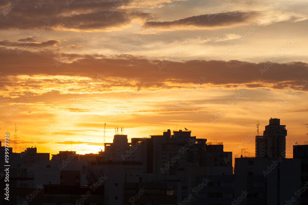 Silhouettes of buildings at dusk in São Paulo city.