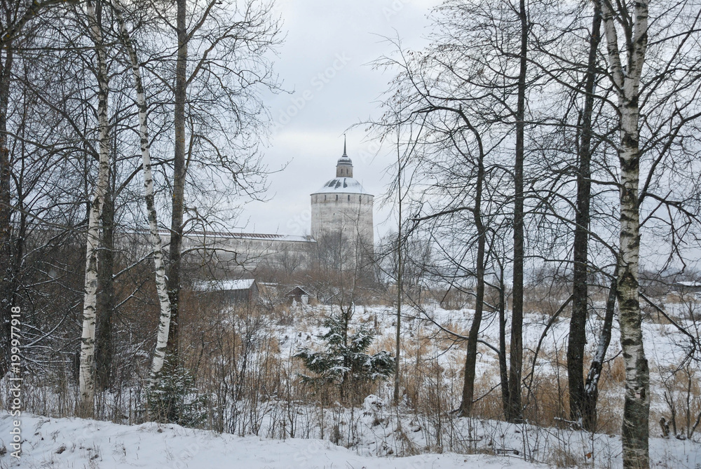 Winter landscape. Edge of forest against the backdrop of the tower of an ancient monastery. Russia. Winter landscape. Edge of forest against the backdrop of the tower of an ancient monastery. Russia.