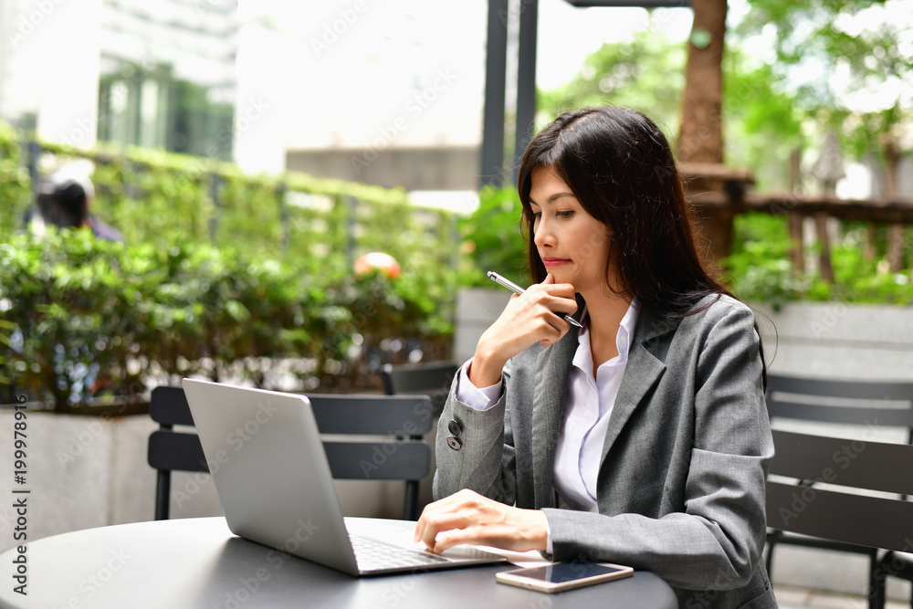 Business Concept.Young Asian businesswoman is working happily.Young businesswoman working in a cafe.Young businesswoman is relaxation in a coffee shop. Business Concept.Young Asian businesswoman is working happily.Young businesswoman working in a cafe.Young businesswoman is relaxation in a coffee shop.