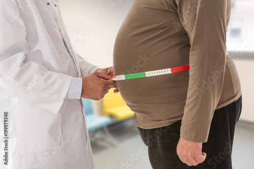 Doctor measuring obese man waist body fat. Obesity and weight loss. photo