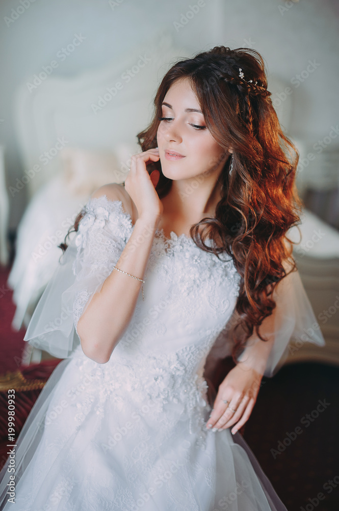 beautiful bride posing in a hotel on a chair beautiful bride posing in a hotel on a chair