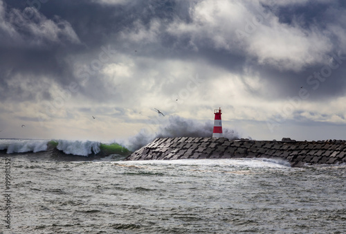 Stormy oceans with big waves crashing into a lighthouse © Paulo Resende