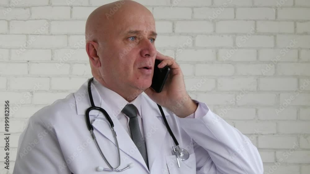 Confident Doctor During Working Time Giving Advice Talking to Mobile Phone Confident Doctor During Working Time Giving Advice Talking to Mobile Phone