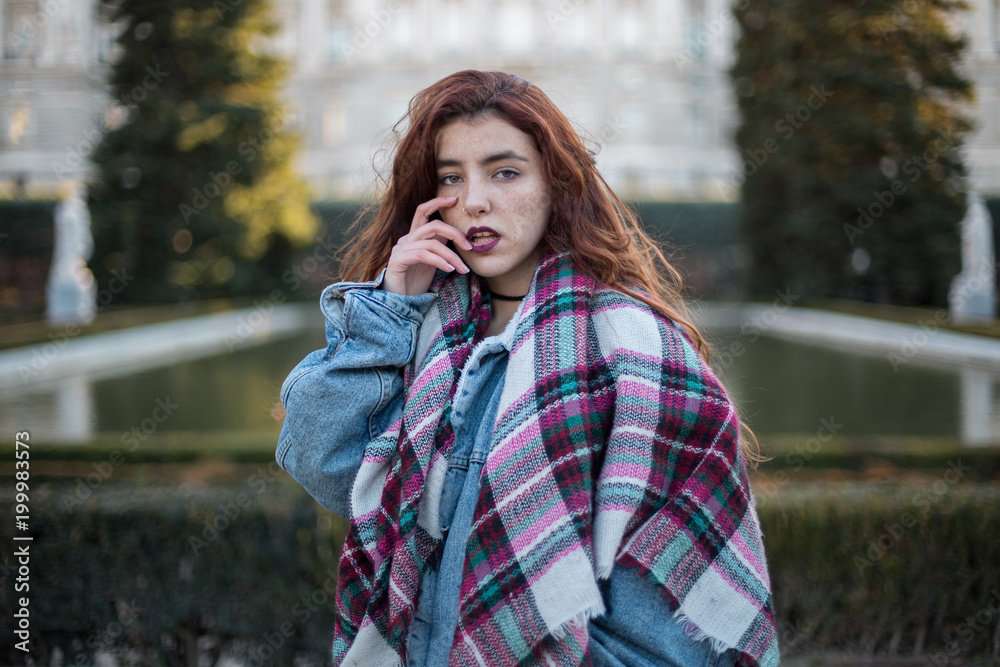 Attractive young girl in denim jacket looking at camera sensually on street. Attractive young girl in denim jacket looking at camera sensually on street.