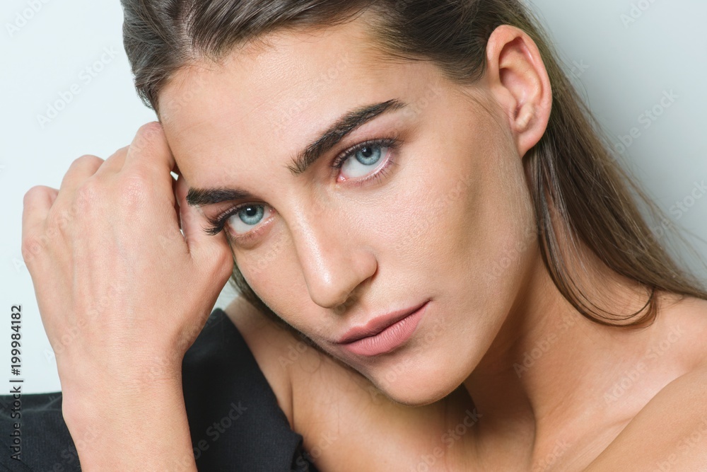 Fashion portrait of young beauty woman with clean skin, natural make-up, blue eyes, long straight healthy hair, sitting on white background. Fashion portrait of young beauty woman with clean skin, natural make-up, blue eyes, long straight healthy hair, sitting on white background.