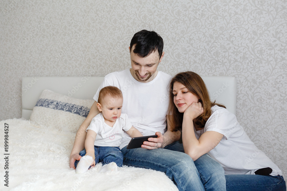 Mom and Dad and show the phone to a small child Mom and Dad and show the phone to a small child