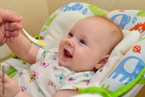 Mom feeds the child with baby puree