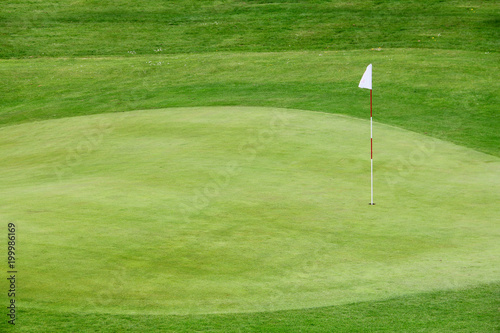 Golf flag on the green grass