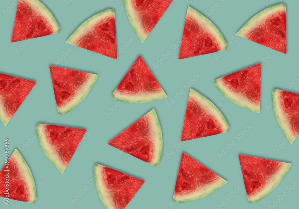 Colorful fruit pattern of fresh watermelon slices on blue background. From top view Colorful fruit pattern of fresh watermelon slices on blue background. From top view