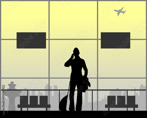 A woman phones at the airport while waiting for her flight, one in the series of similar images silhouette