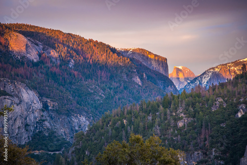 half dome in the distance at sunset at yosemite 