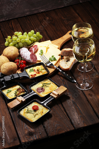 Photography Delicious traditional Swiss melted raclette cheese on diced boiled or baked potato