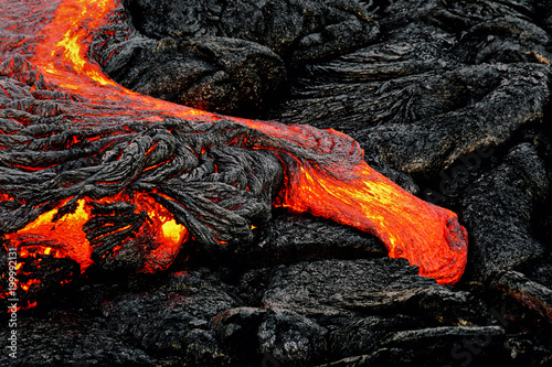 Hot magma escapes from an earth column as part of an active lava flow, the glowing lava slowly cools and freezes - Location: Hawaii, Big Island, volcano "Kilauea"