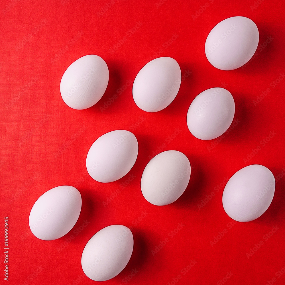 Organic white eggs in a raw on pastel backgound.