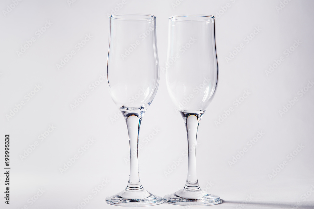 Two empty glasses on a white background