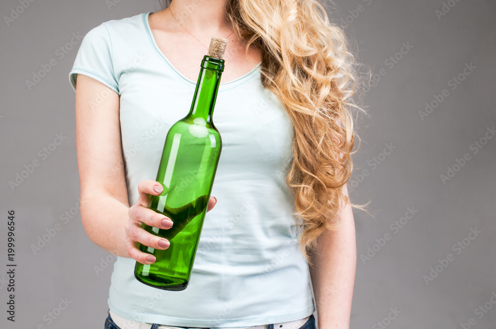 The bottle is in female hands. The bottle is in female hands.