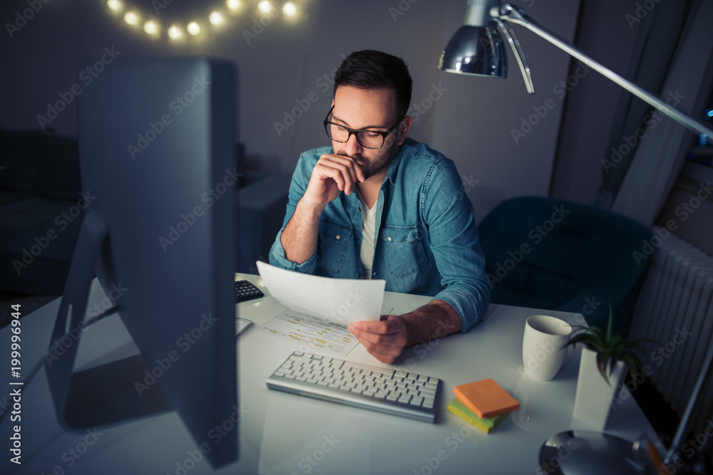 Fotografie Busy man working at home