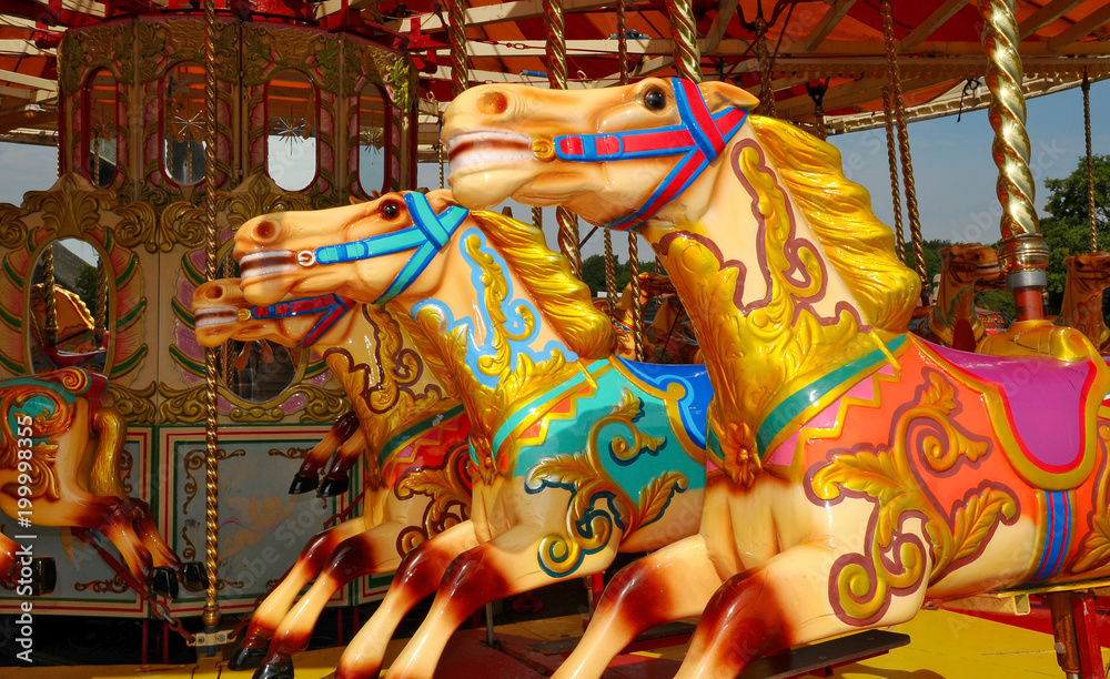 Three colourful carousel horses