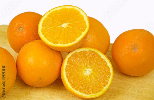 Several oranges and one cut in half