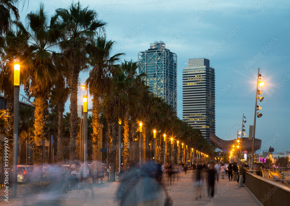 Illuminated quay in Barcelona with blurred people