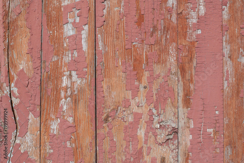 old wooden surface with cracks and peeling paint, pink texture, background