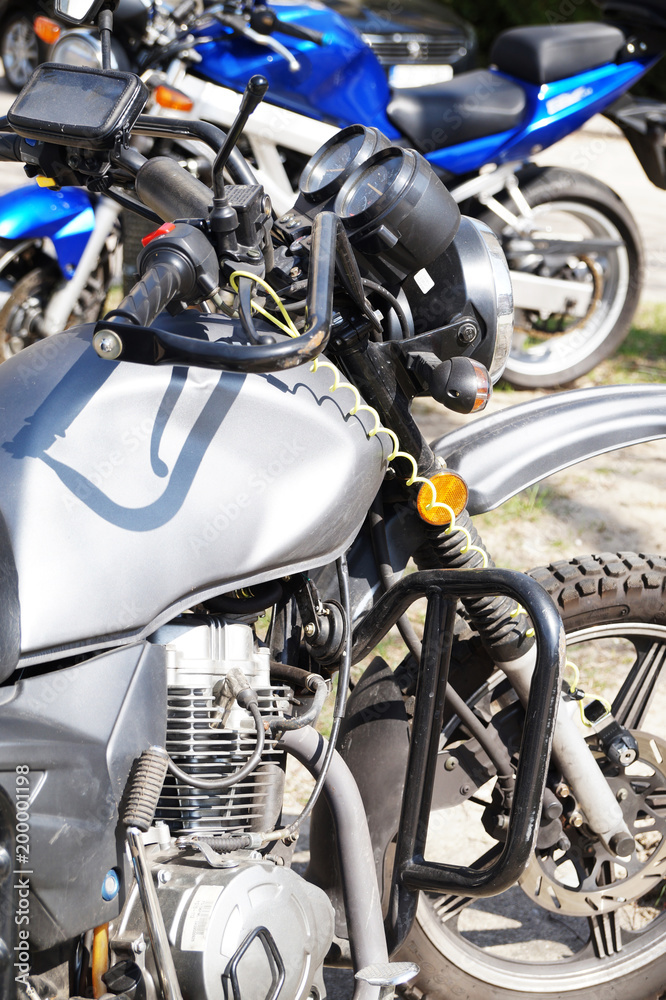 Motorcycles, in the foreground a fragment of a motorcycle, in the background a second motorcycle. Motorcycles, in the foreground a fragment of a motorcycle, in the background a second motorcycle.