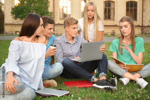 Group of young students sit...